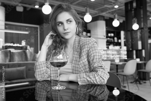 Elegant beautiful brunette woman with glass of red wine