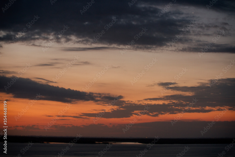 Cloudscape. Beautiful sunset in the Paraná river. Skyline. Panorama view of a dramatic sky and clouds. 