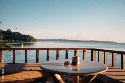 sunglasses on table in front of sea view at resort