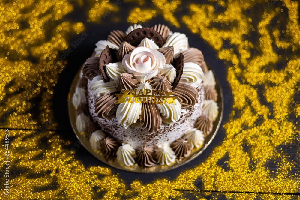 Happy birthday cake with candles, bright lights bokeh. Stock Photo