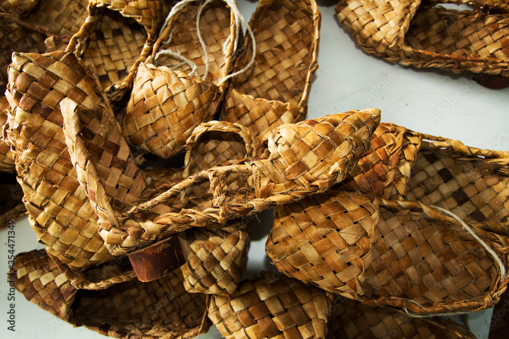 woven shoes made of wood bark from the master on the table