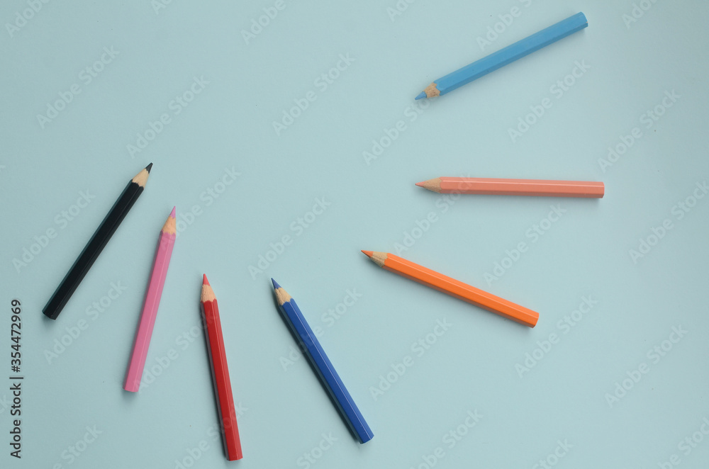 display of the empty space with colored pencils, the concept of colored pencils on a blue background
display of the empty space with colored pencils, the concept of colored pencils on a blue background