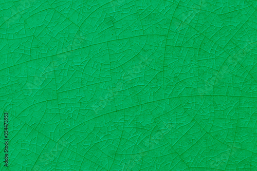 Green crack ceramic tile. Nature color of glazed tile texture abstract background. 