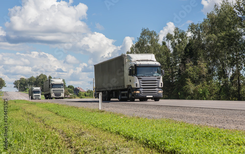 Truck convoy delivers goods on a country road