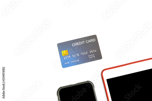 E-Commerce and Mobile Online shopping Concept. Close up of mockup fake credit card with computer tablet and mobile smartphone on isolated white background.
