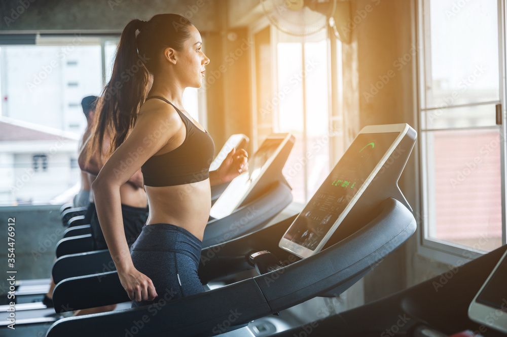 Attractive fitness woman, Sexy sport girl exercising in the modern gym for body muscle workout training, healthy lifestyle portrait Attractive fitness woman, Sexy sport girl exercising in the modern gym for body muscle workout training, healthy lifestyle portrait