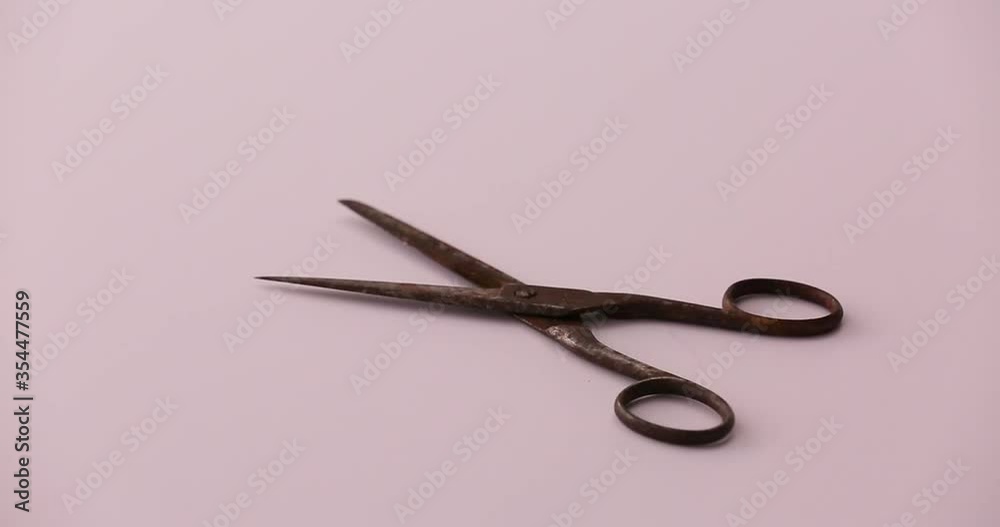 Setting down rusty scissors putting in mixture of sodium bicarbonate and water and cleaning off scissors rusty with a rag Setting down rusty scissors putting in mixture of sodium bicarbonate and water and cleaning off scissors rusty with a rag
