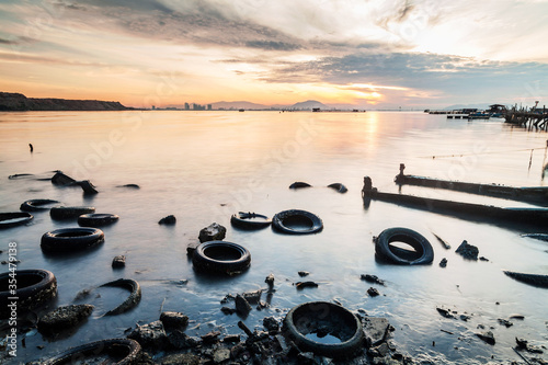 Tyres dump site view from the shore photo