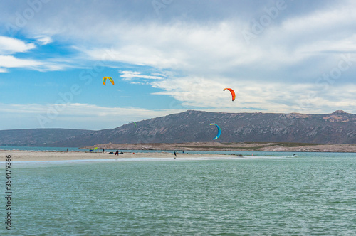People kite surfing in Langebaan seaside town in South Africa photo