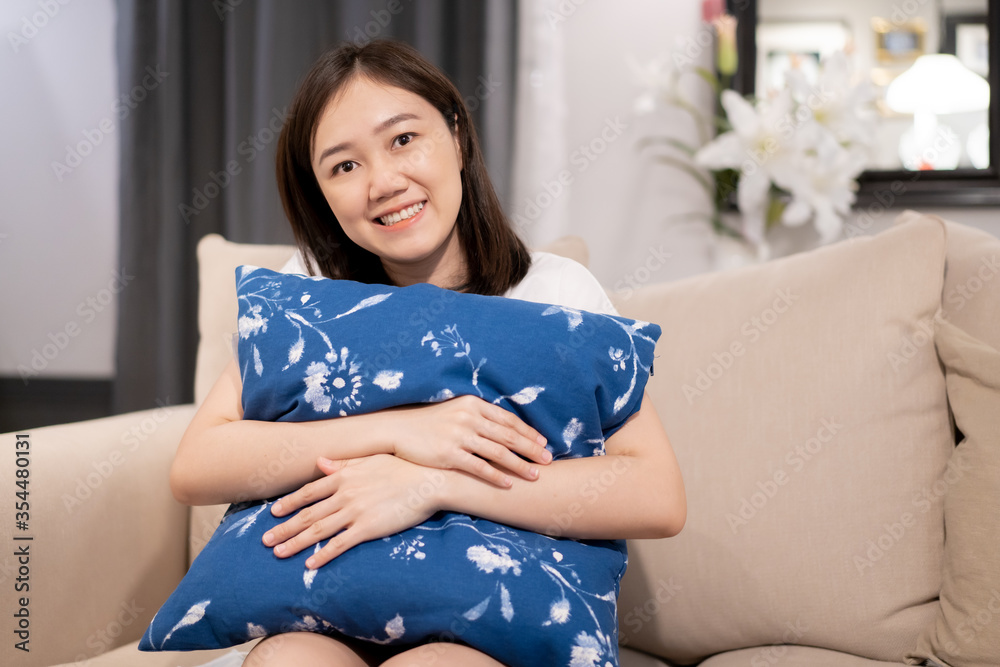 Asian stay and relax herself in the living room and watching a television (TV) during quarantine period. Asian stay and relax herself in the living room and watching a television (TV) during quarantine period.