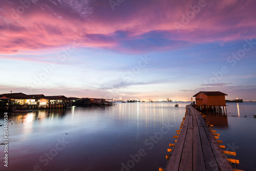 Wooden bridge Clan Tan Jetty view during sunrise in George Town, Penang