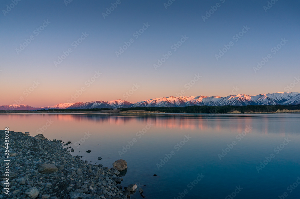 Sunrise winter mountains landscape with calm lake and water reflections Sunrise winter mountains landscape with calm lake and water reflections
