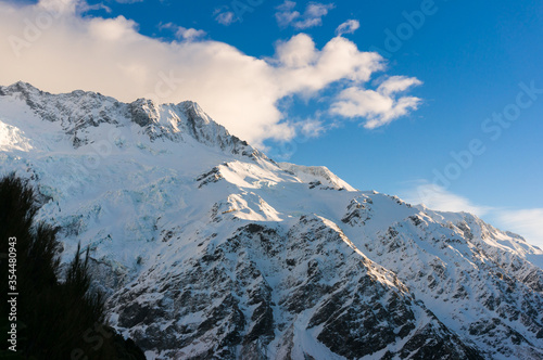 Winter mountain landscape with snow covered mountains and blue sky