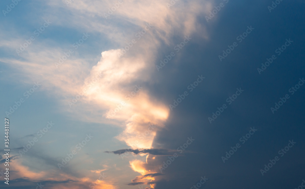 
Beautiful dramatic gray and white clouds on blue sky, variety of shapes, silhouettes and shades at sunset time