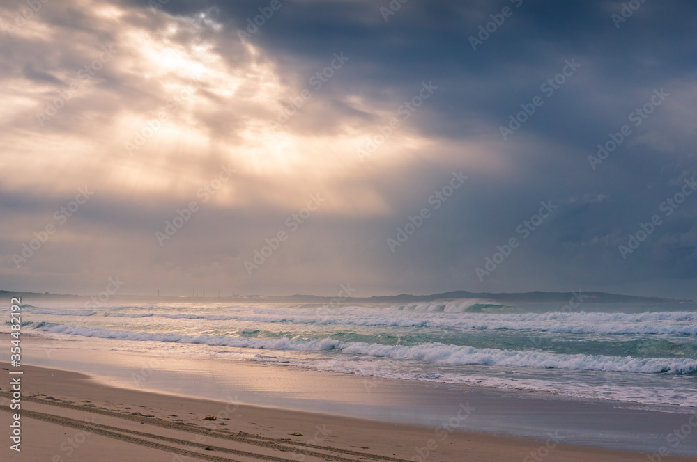 Beach sunrise landscape with soft waves and beautiful sunlight