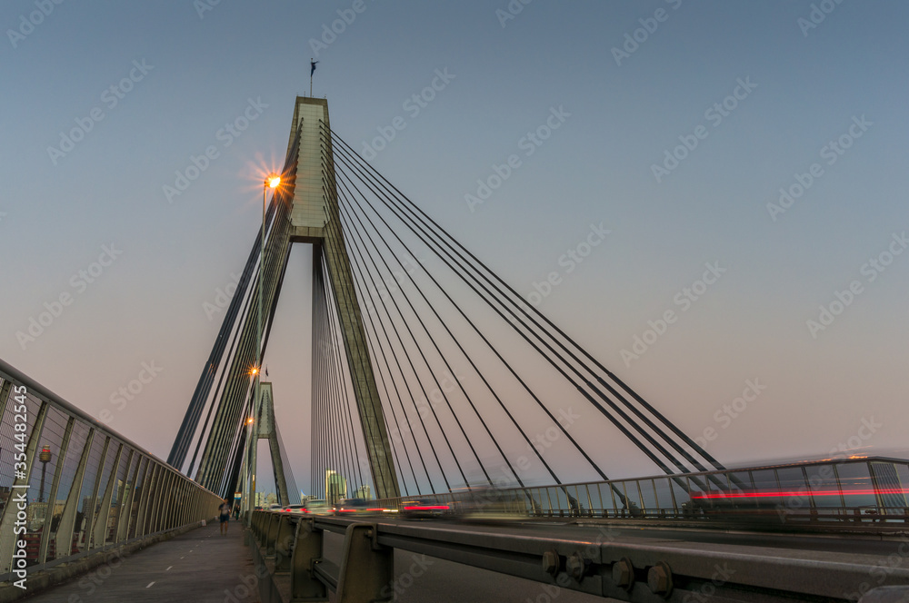 Fototapeta premium Evening traffic on a bridge. ANZAC bridgewith car lights at night
