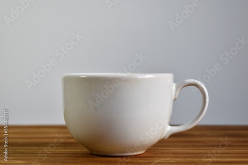 a white coffee cup on a table