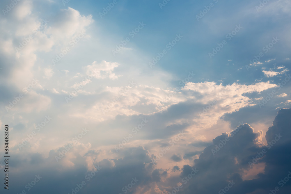 
Beautiful dramatic gray and white clouds on blue sky, variety of shapes, silhouettes and shades at sunset time