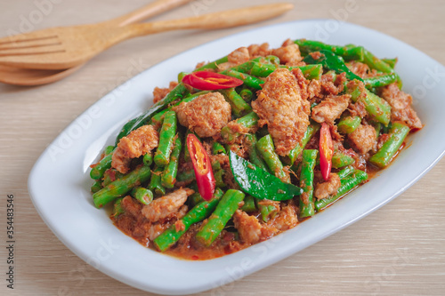 Stir fried pork with yard long bean and red curry paste, Thai food photo