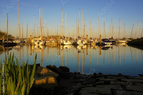 View of the harbor by sunset from the slipway with grass in the foreground. photo