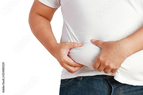 Fat Asian men use their hands to squeeze their stomachs. He is overweight and is the cause of many diseases. Health care concept. Clipping path. White background photo