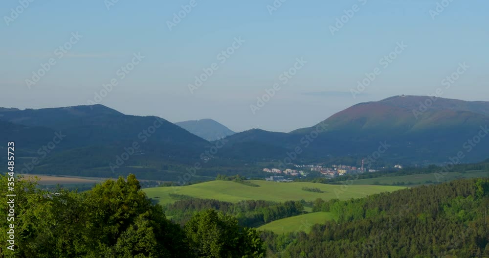 Zoom inside mountainous landscape of the protected area of the Beskydy Mountains with a view of the surrounding forests and the valley in which the town of Zubri lies. Zoom inside mountainous landscape of the protected area of the Beskydy Mountains with a view of the surrounding forests and the valley in which the town of Zubri lies.