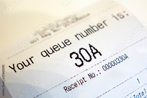 Close up of Coffee Receipt slip with queue number on it.