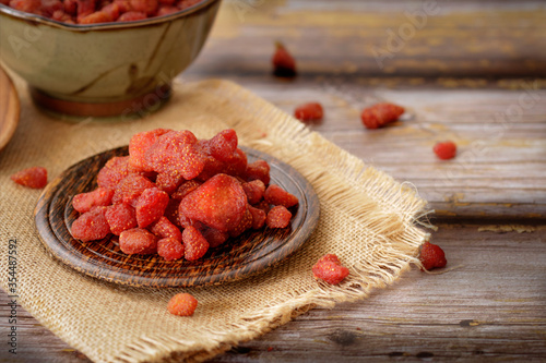 Dried fruits, Strawberry in dark wooden plate on vintage wooden backgrounds. Selective focus.