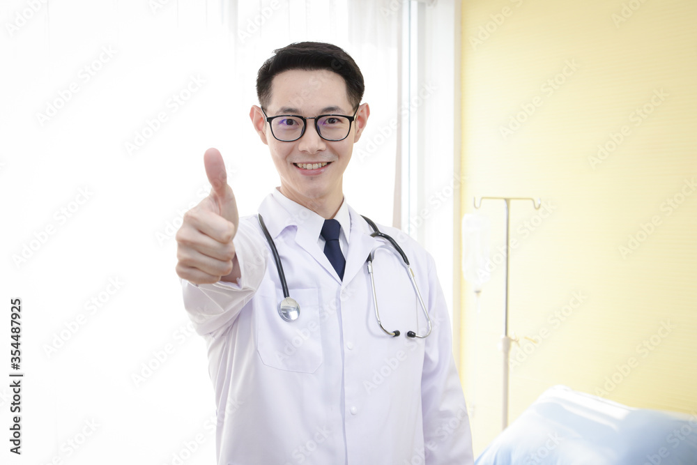 The Asian doctor raised a thumbs up and was confident in treating the patient. Hospital concept The Asian doctor raised a thumbs up and was confident in treating the patient. Hospital concept
