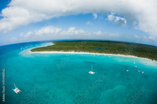 Beach aerial drone view from above on Punta Cana landscape, Bavaro, Saona, Cap Cana tropical ocean sea and palm trees on caribbean coastline with tourists and boats in Dominican republic Cortecito 