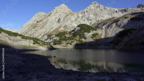 Wind ripples the quiet surface of Drachensee, a mountain lake high in the alps. Tirol, Austria photo