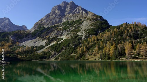 View of Sonnenspitze mountain in autumn with the tranquil lake Seebensee in the foreground. Alps, Austria photo