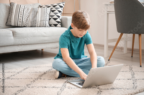 Cute little boy with laptop...