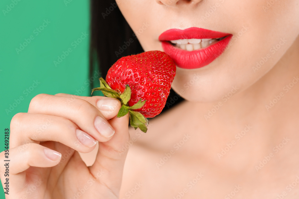 Sexy young woman with strawberry on color background, closeup Sexy young woman with strawberry on color background, closeup