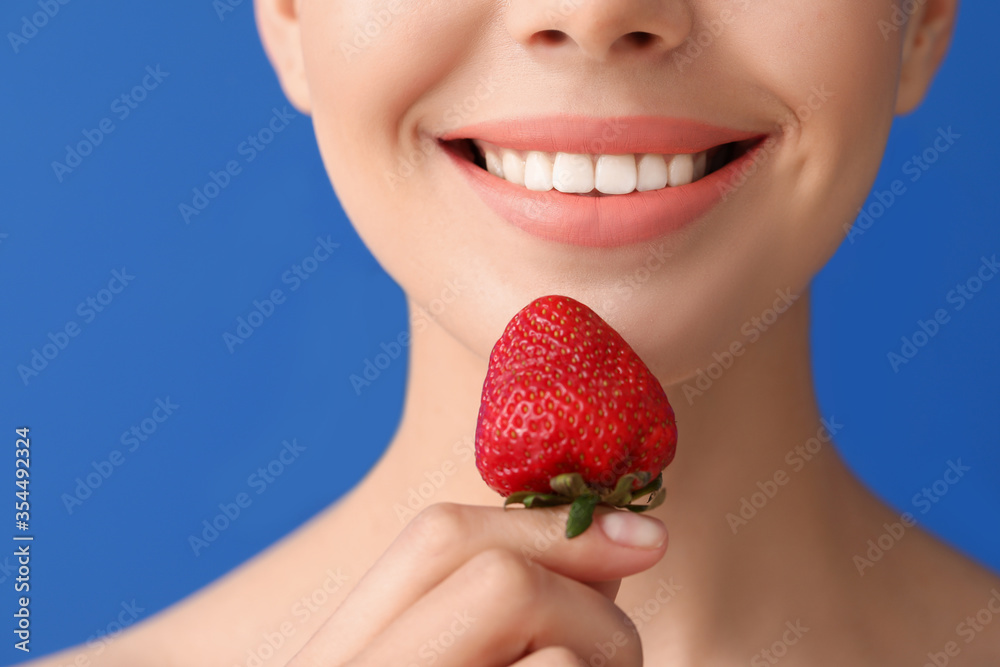 Sexy young woman with strawberry on color background, closeup Sexy young woman with strawberry on color background, closeup