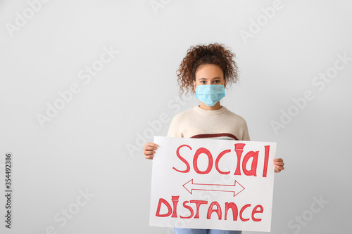 Young woman holding paper w...
