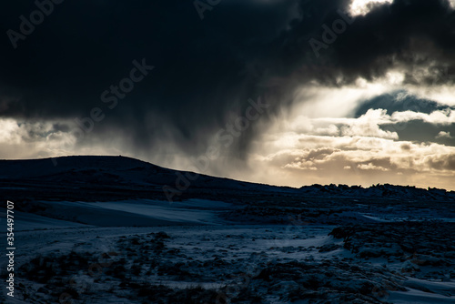 Dramatic dark storm clouds over winter landscape Iceland