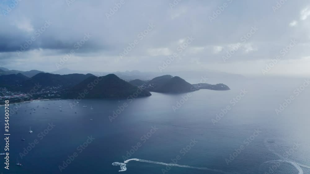 Drone camera shoots the hilly coast with the city and yachts in the sea bay (Rodney Bay, Saint Lucia) Drone camera shoots the hilly coast with the city and yachts in the sea bay (Rodney Bay, Saint Lucia)