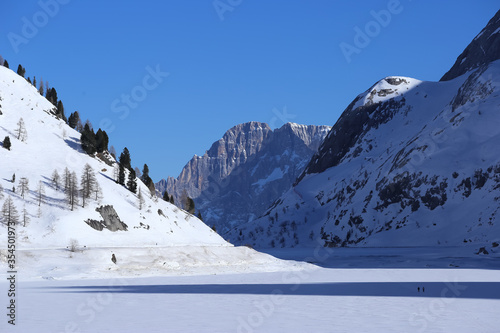 Passo Fedaia, Italy, 02/21/2020 , View of Fedaiaa lake from the dam. Passo Fedaia is a mountain pass traversed by a paved road in the Dolomiti Range in Northern Italy.