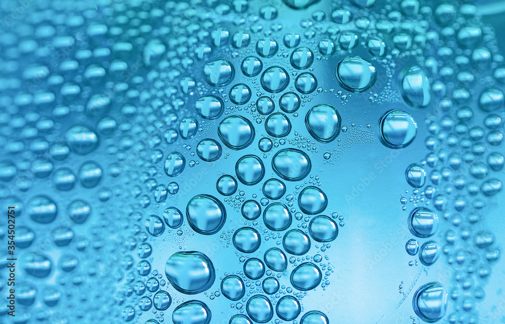 Close up water drops on sky blue tone background. Abstract sky blue wet texture with water drops on glass surface. 