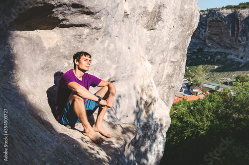 Man sitting on a rock.