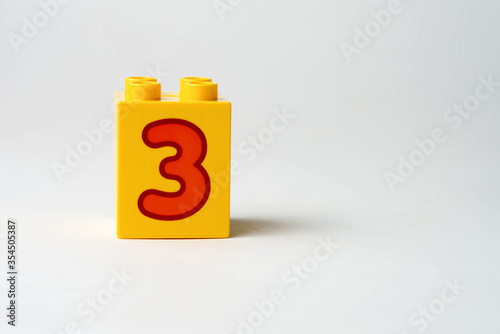 the number three written on the block from the children's constructor
