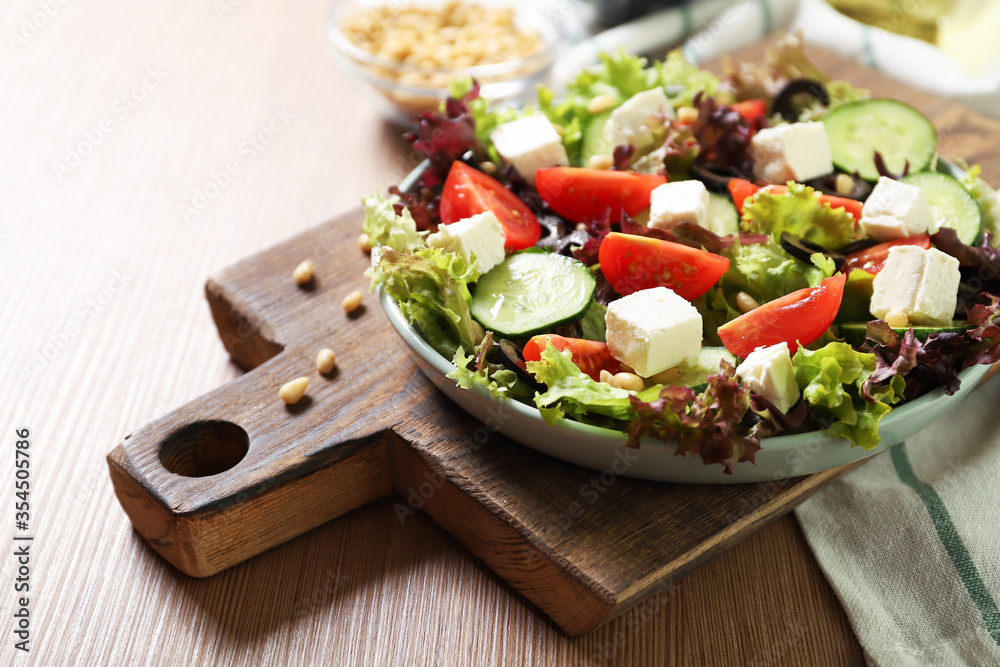 Plate with tasty greek salad on the table. Salad recipe Plate with tasty greek salad on the table. Salad recipe
