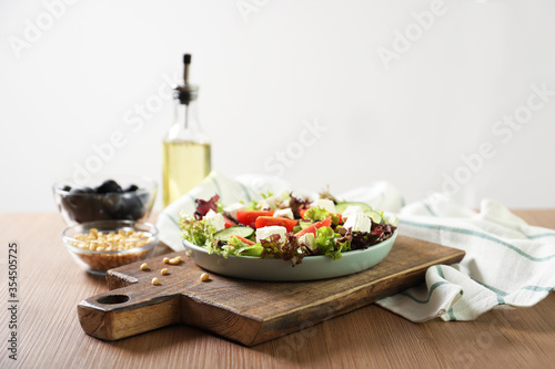 Plate with tasty greek salad on the table. Place for text