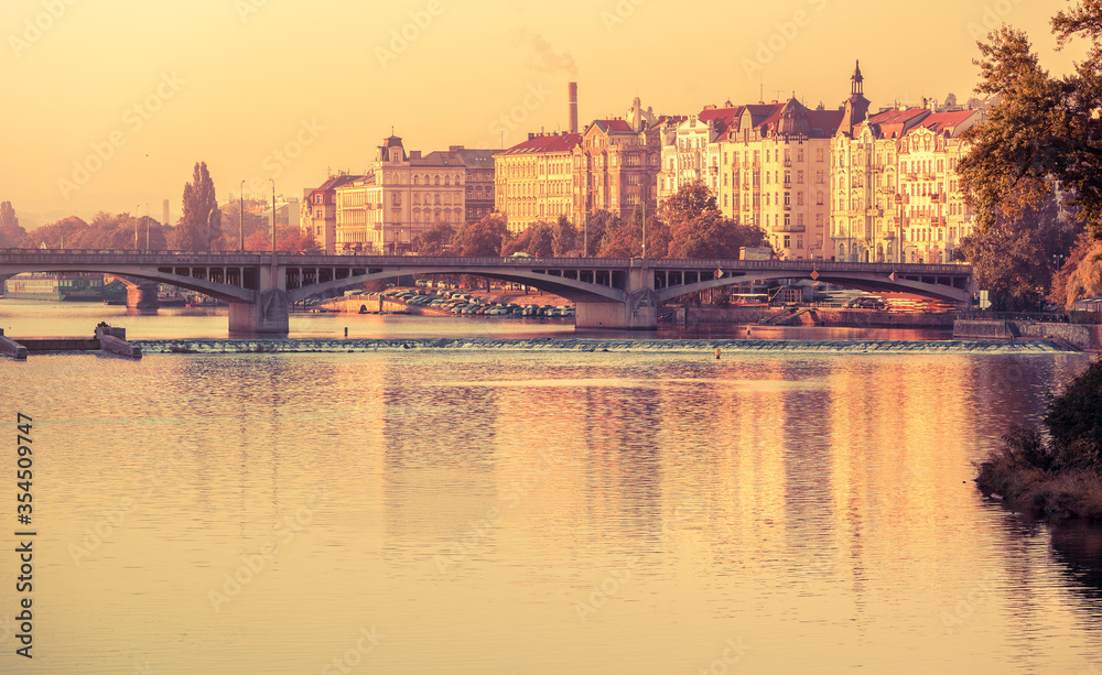 Czech Republic Prague. View of river Vltava, house on coast and bridge. Picturesque urban morning landscape. Touristic landmark.