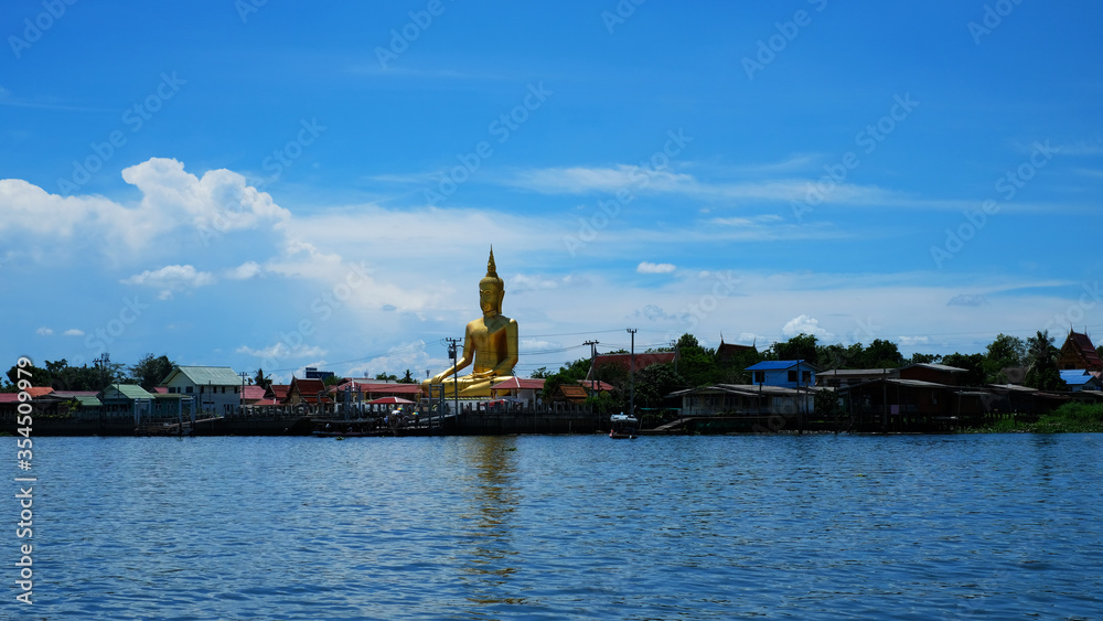 Big sitting Buddha image on bank of a river