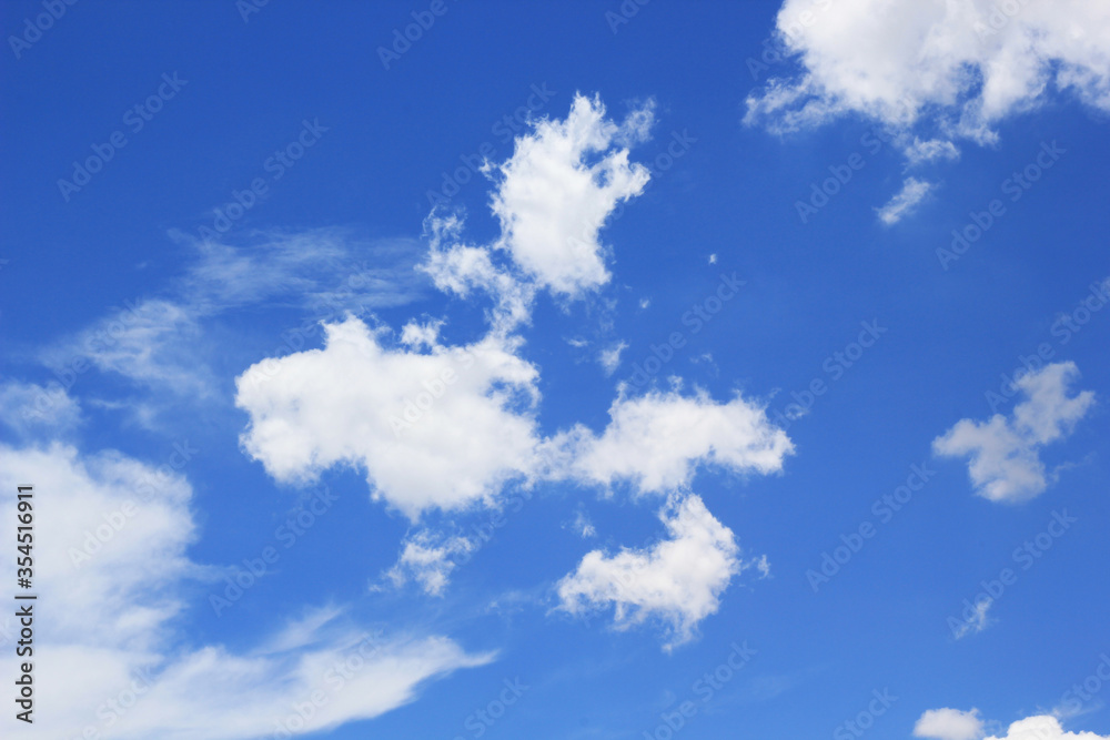 Obraz premium beautiful white cloudy on blue sky background at noon in Thailand