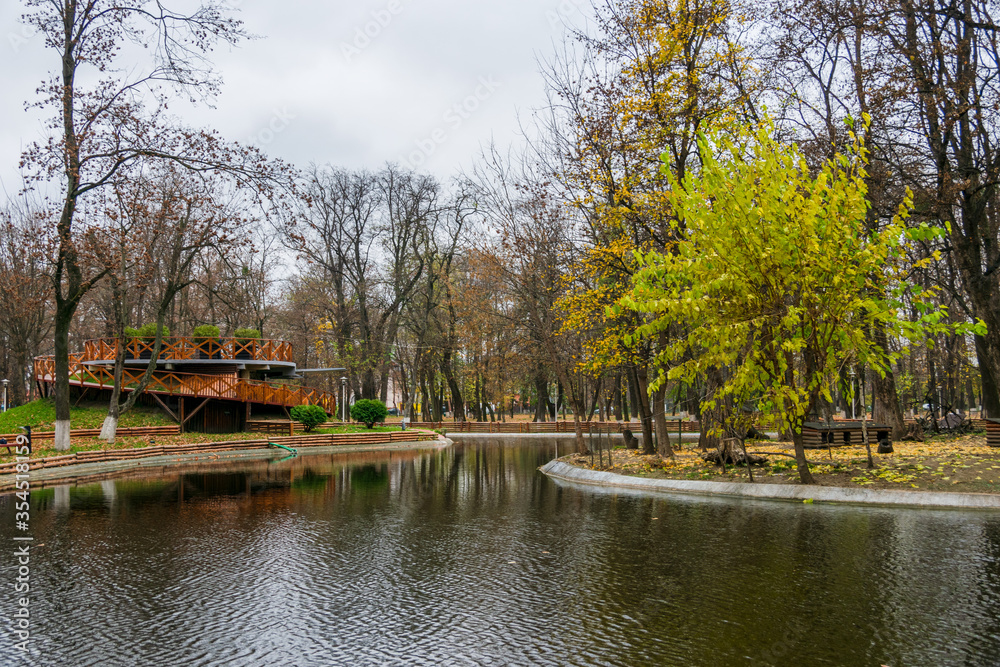 The recreational lake in the Roman park reflecting the colors of autumn, Romania