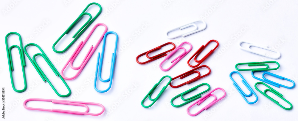 Colored paper clips close-up on a white background Colored paper clips close-up on a white background