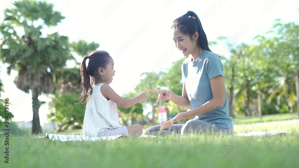 Mother and daughter sit and rest together in the park. Mother and daughter sit and rest together in the park.